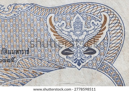 Macro texture of intricate guilloche patterns on Thai banknote