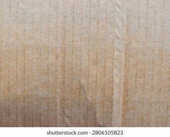 Macro texture shot showcasing the vertical lines, fibers, and detailed grain of a brown corrugated cardboard sheet.