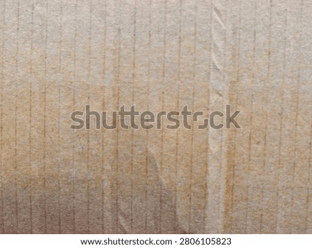 Macro texture shot showcasing the vertical lines, fibers, and detailed grain of a brown corrugated cardboard sheet.