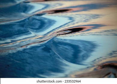 macro texture whimsical waves on the river at sunset time