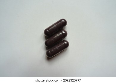 Macro Of Three Dark Purple Capsules Of Bilberry Extract Dietary Supplement