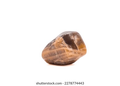 Macro tumbled dark peach moonstone crystal, aluminium silicate mineral, brown and peach gem isolated on a white background surface