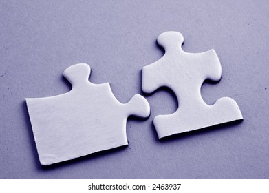 Macro of two puzzle pieces fitting together