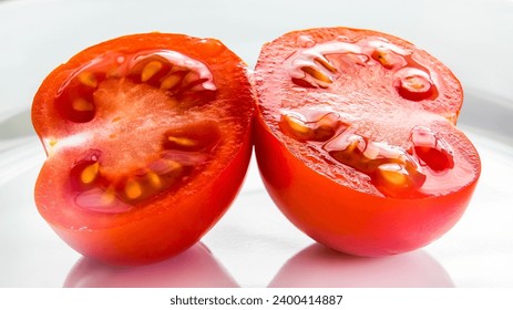 Macro from two tomato halves on white plate - Powered by Shutterstock