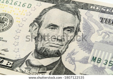 Macro view of Abraham Lincoln on the US five dollar bill.