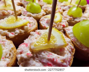 macro view of appetizer, canape, party food, finger food with surimi spread, lemon and grape - Shutterstock ID 2277702857