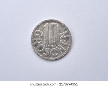 Macro view of the Austrian coin valued ten Groschen in a scalloped rim with the denomination in the center above the year translated as 