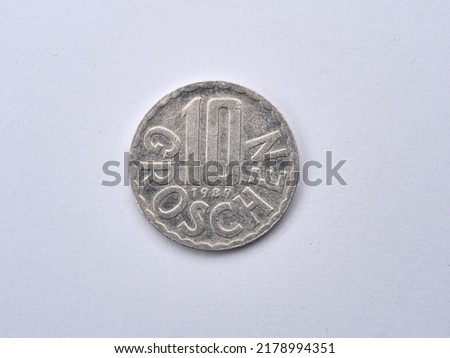 Macro view of the Austrian coin valued ten Groschen in a scalloped rim with the denomination in the center above the year translated as 