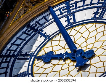 Macro view of Big Ben clock face with blue hands and ornate gold detail capturing a precise moment in time; ideal for concepts of punctuality, deadline, schedule, London branding