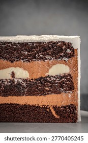 Macro view of chocolate cake slice with rich cream layers and filling, emphasizing texture, softness and premium dessert quality for bakery presentation.