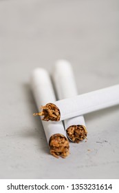 Macro View Of The Cigarettes And Tobacco Stack. The Tobacco Plant Is Part Of The Genus Nicotiana And Of The Solanaceae (nightshade) Family. Close Up With Copy Paste Space, In The Gray Background