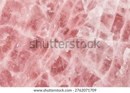 Macro view of the delicate pink texture of a rose quartz gemstone, showcasing its unique natural crystalline structure. Ideal for backgrounds in beauty, wellness, or abstract design projects.