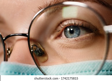 Macro View Of Doctor In Medical Mask Looking Away Wearing Glasses