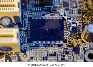 Macro view of electronic circuit board with microchip and various components in blue tones