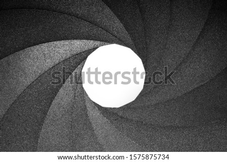 Macro view of the inside of a camera lens showing the aperture diaphragm blades