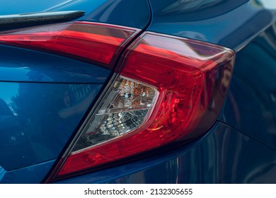 Macro view of modern blue car xenon lamp taillight, bumper, rear trunk lid. Exterior of a modern car