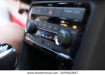 Macro view of a modern car’s climate control console set to 20°C, showing buttons, dials, and indicator lights. Shallow depth of field and soft bokeh emphasize the sleek automotive interior.
