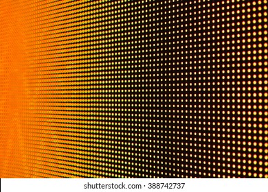 MACRO VIEW OF ORANGE LED SCREEN DISPLAY WITH LOW DEPTH OF FIELD