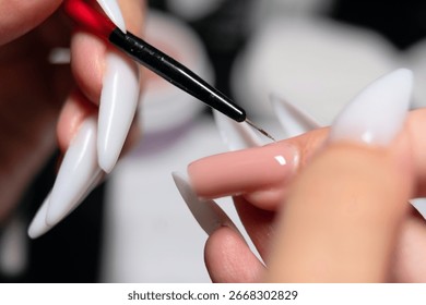 Macro view of professional using miniature brush to create flawless gel polish application during nail enhancement service.