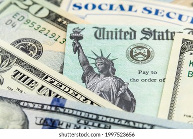 Macro View Of The Statue Of Liberty On A United States Treasury Check With Social Security Card In Background.