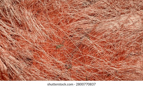 Macro view of tangled copper wire shavings forming a dense mesh.