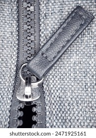 Macro View of a Zipper Pull on a Half-Opened Fly