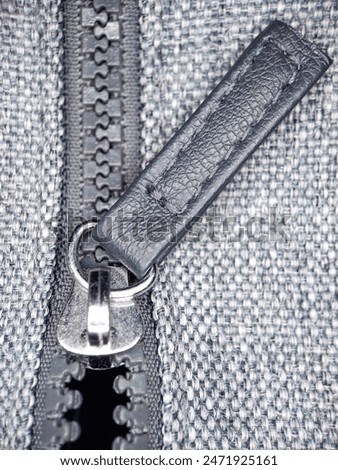 Macro View of a Zipper Pull on a Half-Opened Fly