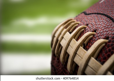 Macro of a vintage worn american football ball with visible laces, stitches and pigskin pattern