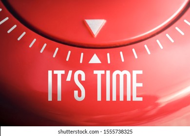 Macro Of The Words IT'S TIME On A Flat Red Kitchen Egg Timer