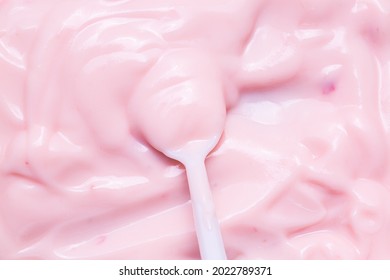 Macro Yogurt,Strawberry Frozen Yogurt Background Close Up. Strawberry Ice Cream Texture Close Up. Top View. Pink Fruit Ice Cream Background With Small Pieces Of Berries