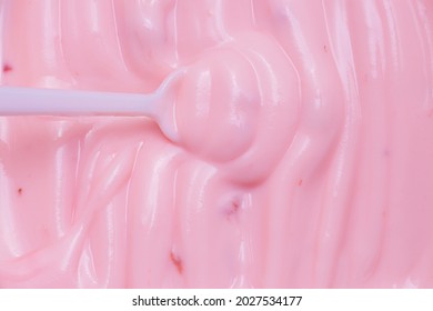 Macro Yogurt,Strawberry Frozen Yogurt Background Close Up. Strawberry Ice Cream Texture Close Up. Top View. Pink Fruit Ice Cream Background With Small Pieces Of Berries