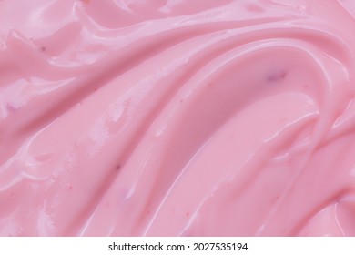 Macro Yogurt,Strawberry Frozen Yogurt Background Close Up. Strawberry Ice Cream Texture Close Up. Top View. Pink Fruit Ice Cream Background With Small Pieces Of Berries