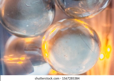 Macrophotography of multicolored glass, shiny balls on a luminous background, bokeh, balls glow from the inside, blurred circles, lights. Ball, pattern, background blur, holiday fireflies, space, boke