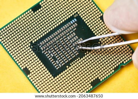Macro-shot of computer microchip processor. Global chip and semiconductor shortage. Symbol of ongoing crisis in car industry. Concept of high demand for integrated circuits