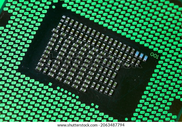 Macro-shot of computer\
microchip processor. Global chip and semiconductor shortage. Symbol\
of ongoing crisis in car industry. Concept of high demand for\
integrated circuits