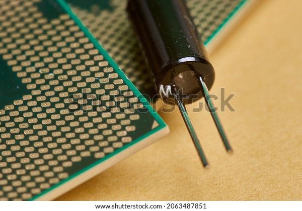 Macro-shot of computer
microchip processor. Global chip and semiconductor shortage. Symbol
of ongoing crisis in car industry. Concept of high demand for
integrated circuits