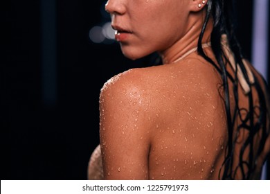 Macroshot Of Texture Of Wet Female Shoulder And Back With Drops Of Water On Tanned Healthy Young Skin. Woman At Bathroom Close Up.