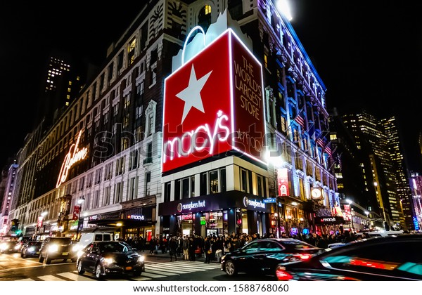 Macy\'s\
Herald Square Flagship Department Store in Midtown Manhattan with\
people crossing the street in front of it and yellow taxi\'s riding\
by. Manhattan, New York, USA - June 10,\
2015