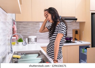 mad asian woman hate to do some chores. housewife hate washing dish