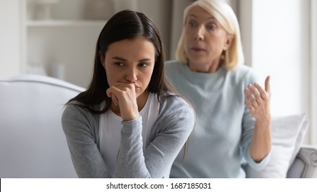 Mad bothered millennial girl annoyed by authoritative lecturing senior mother scolding quarreling, pensive distressed grown-up adult daughter ignore angry mature mom talking, generation gap concept