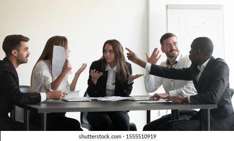 Mad frustrated multiethnic employees sit at office meeting dispute quarrel have stressful job situation, angry diverse colleagues debate fight over paperwork financial statistics, work stress concept - Shutterstock ID 1555510919