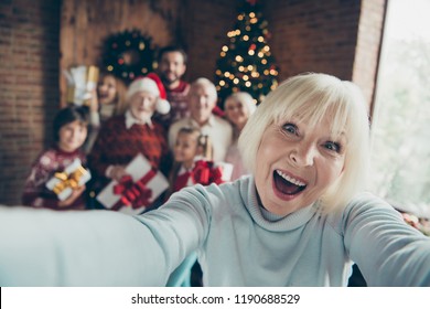 Mad Funny Funky Granny Grandma. Self-portrait Of Cheerful Ecstatic Grey-haired Grandma. Noel Gathering. Grandparents Grandchildren, Sister, Brother, Son, Daughter At House Party, Meeting Near Fir Tree