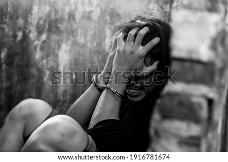 Mad guy was cuffed and under arrest by policeman and detain prisoner in jail Detainee is delirium tremens and get insane in prison. Young prisoner get withdrawal symptoms Criminal and drug concept
