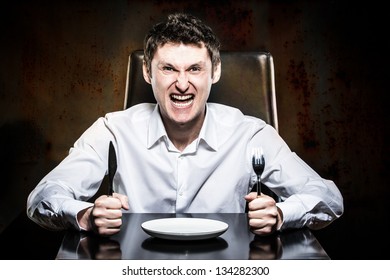 Mad Man Waiting His Food In A Restaurant