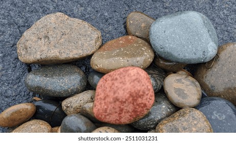 The Mad Mix of Rocks of Swamis Beach. Rounded and polished from tumbling in fast moving streams and ocean waves rocks of many ethnic origins together at Swamis Reef Surf Park Encinitas California. - Powered by Shutterstock