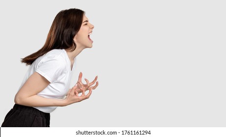 Mad woman portrait. Horror frustration. Insane lady isolated screaming at light empty space. - Shutterstock ID 1761161294