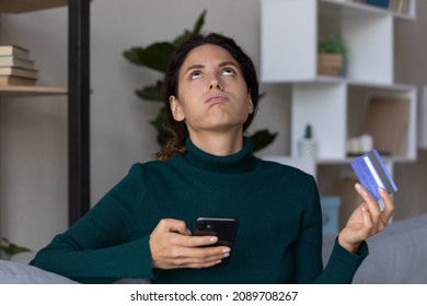 Mad young Latino woman pay buy online on cellphone distressed with mistake or error on bank app page. Unhappy Hispanic female buyer shopping on internet on smartphone, have debt bankruptcy problem.