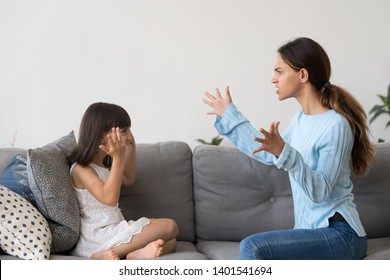 Mad Young Mom An Little Daughter Sit On Couch Have Fight Arguing Gesturing, Furious Angry Mother Yell Dispute With Preschooler Girl, Annoyed Parent Lecture Small Child Imitating Play Pretend Similar