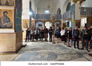 Madaba, Jordan - February 16, 2020. Unidentified people in Greek Orthodox Basilica of St. George, in Madaba, Jordan. 