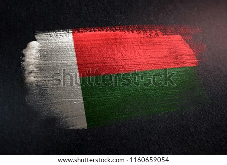 Madagascar Flag Made of Metallic Brush Paint on Grunge Dark Wall